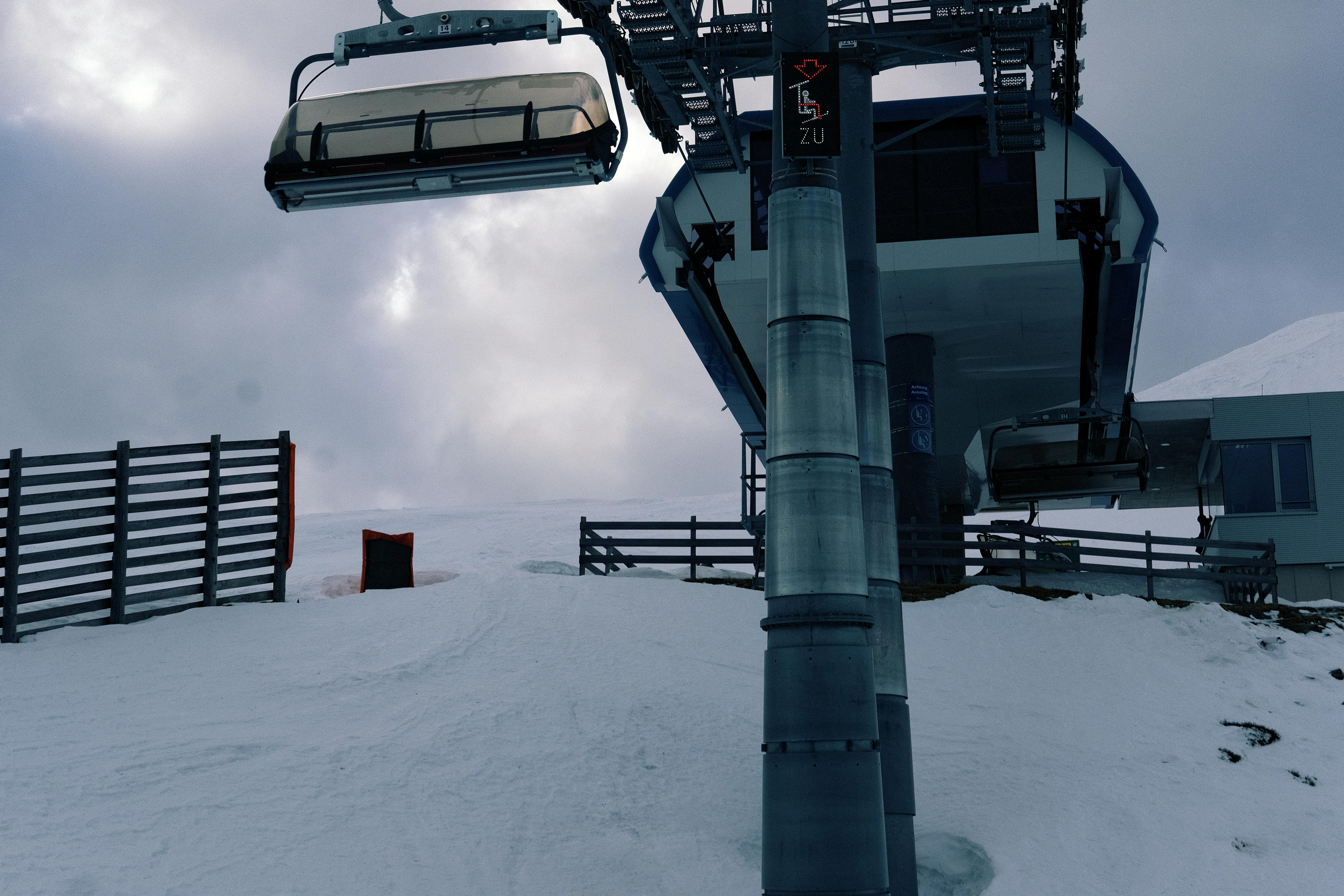 A ski lift at a snowy mountain, perfect for winter tourism and adventure.