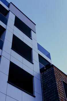 Contemporary urban building facade captured in a low angle showcasing modern architecture.