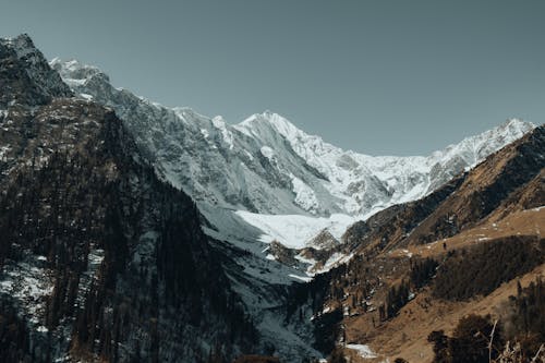 A mountain range with snow covered peaks