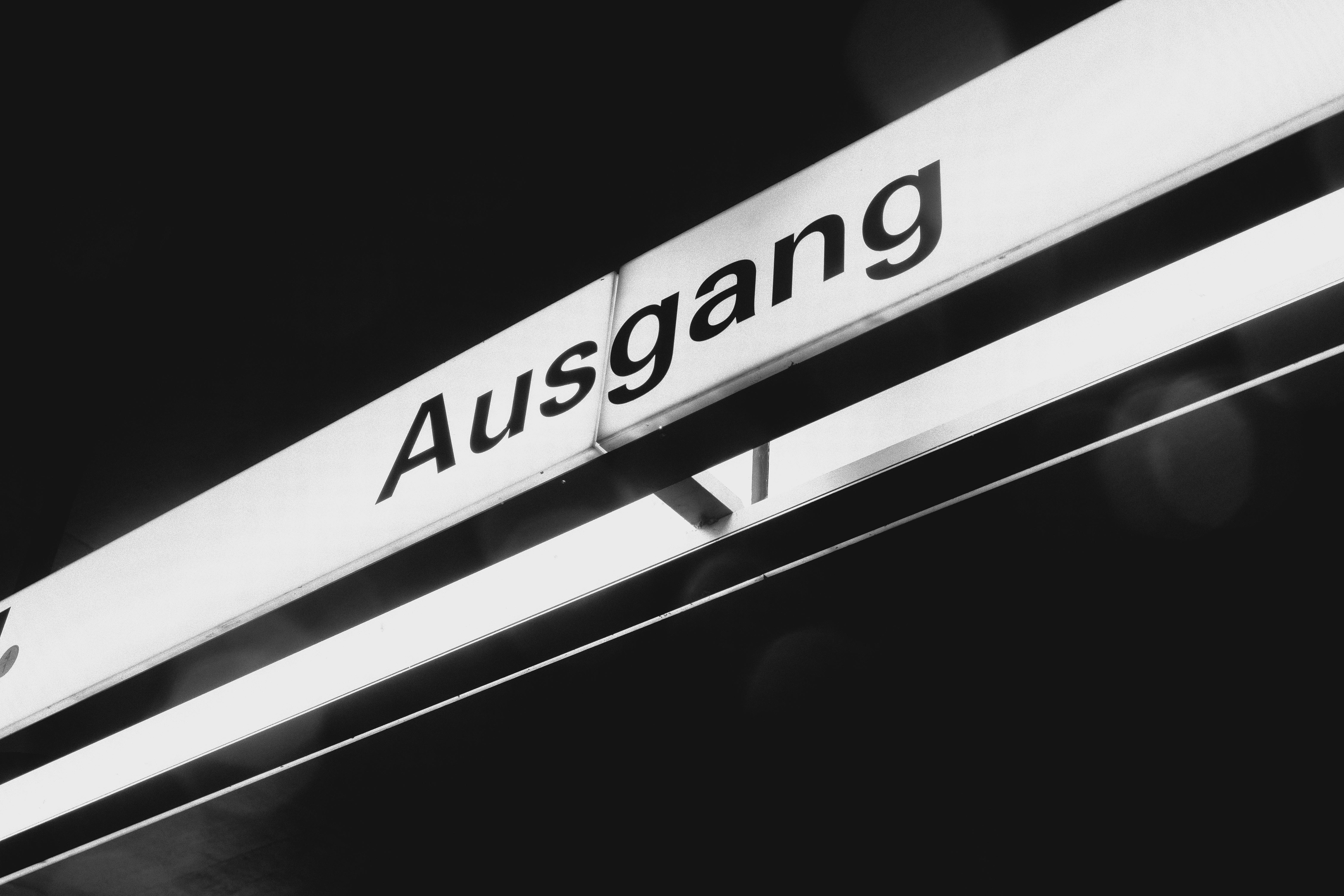 Black and white image of a German exit sign with 'Ausgang' text.