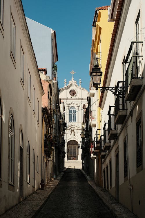 A narrow street with a church on the side