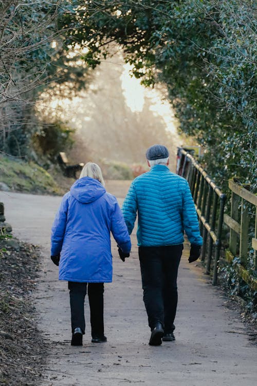 An older couple walking down a path