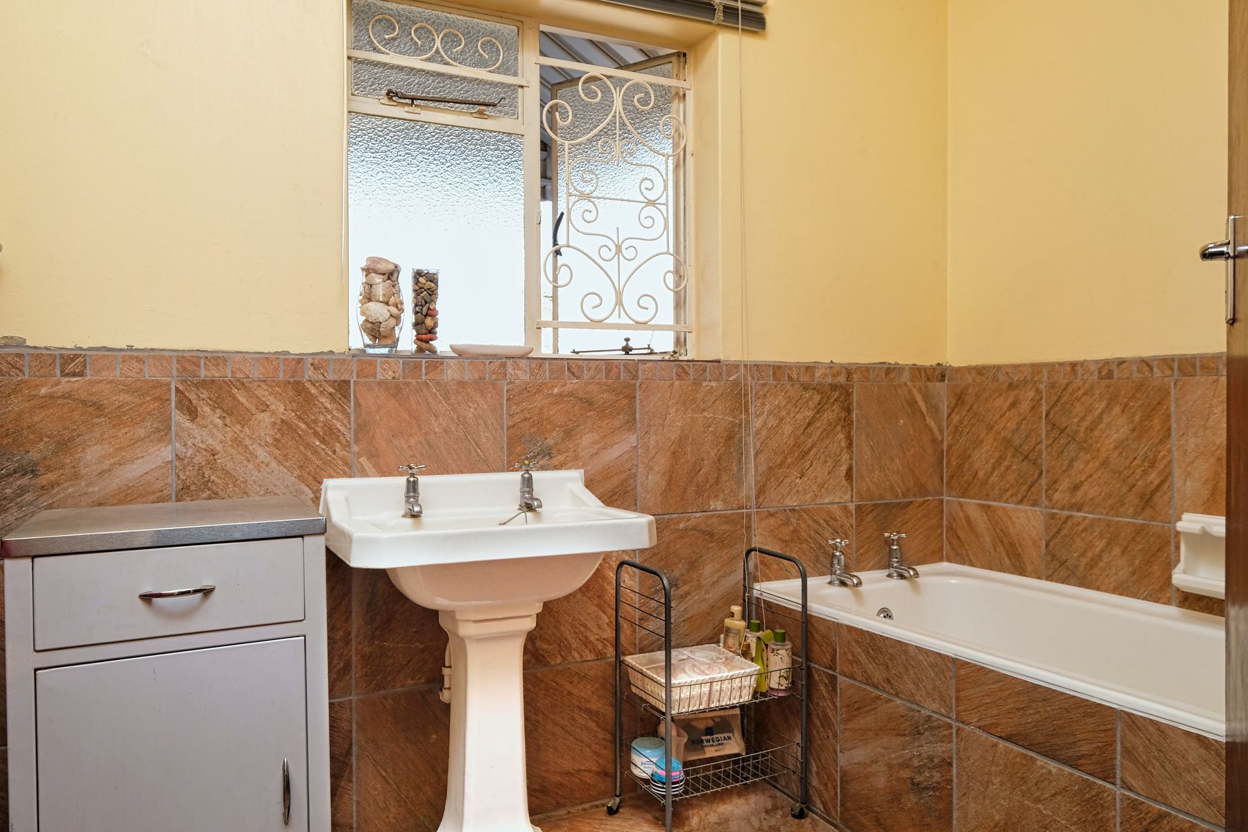 Rustic bathroom with textured stone tile and warm natural materials