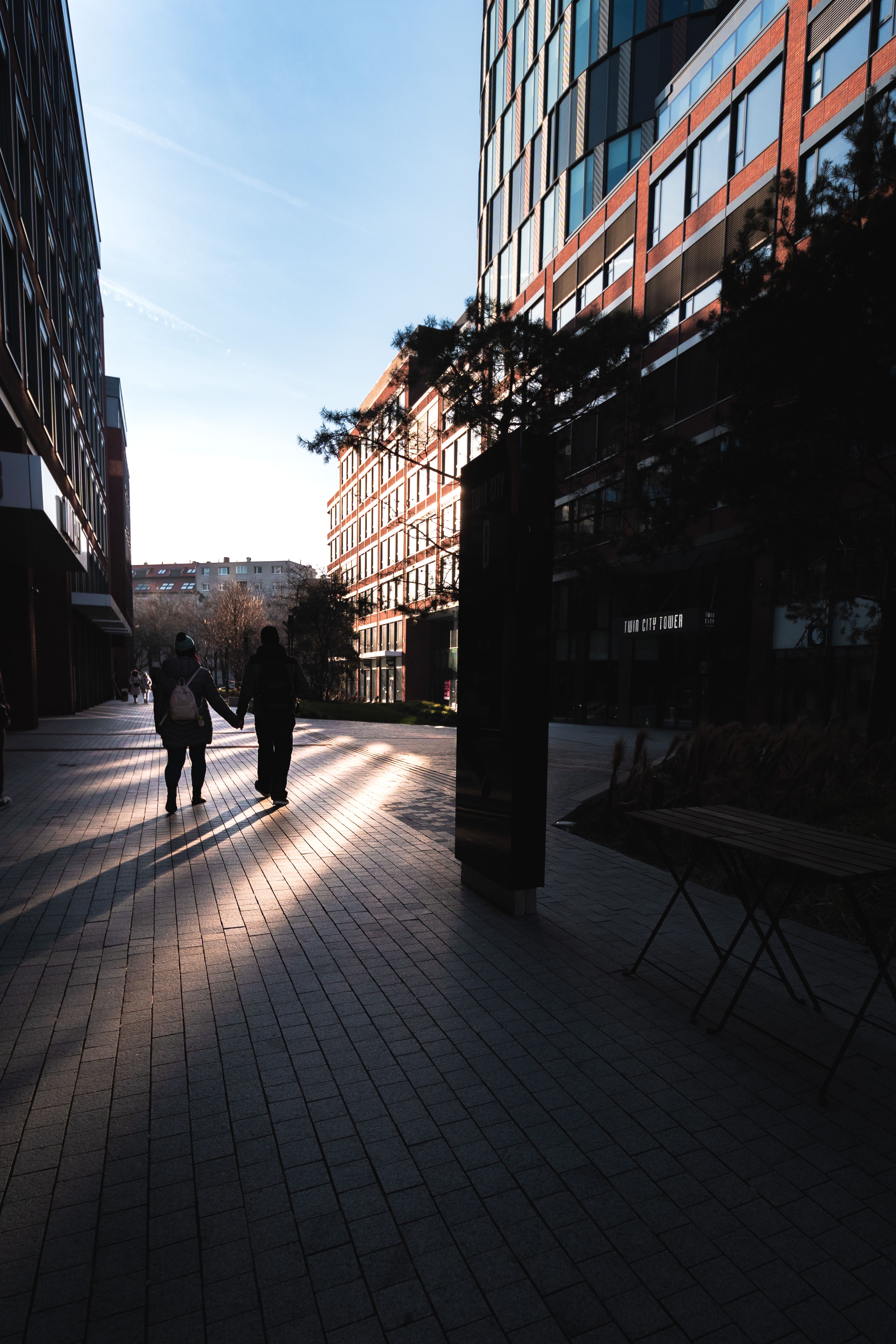 Couple Walking on Pavement in Shadow · Free Stock Photo