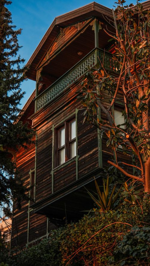 Free A beautiful wooden house in İstanbul with a balcony, captured at sunset. Stock Photo