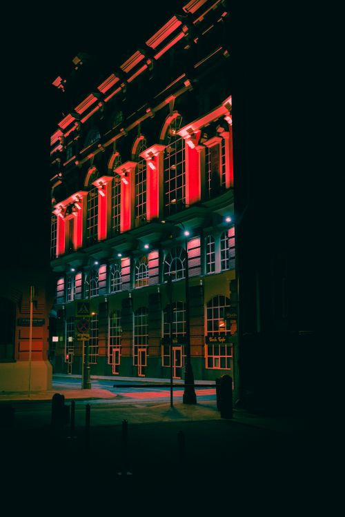 Free Dramatic view of an illuminated building with red lights in Moscow at night, showcasing urban architecture. Stock Photo