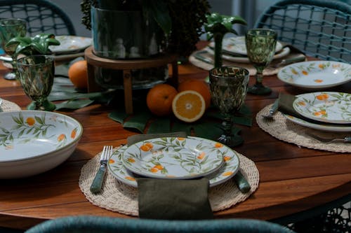 A table set with plates, bowls and glasses