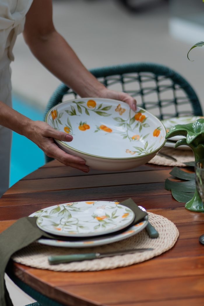 Hand-painted floral plates laid on a summer table, photo by Wolf Art on Pexels