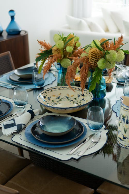 A table setting with blue plates and bowls