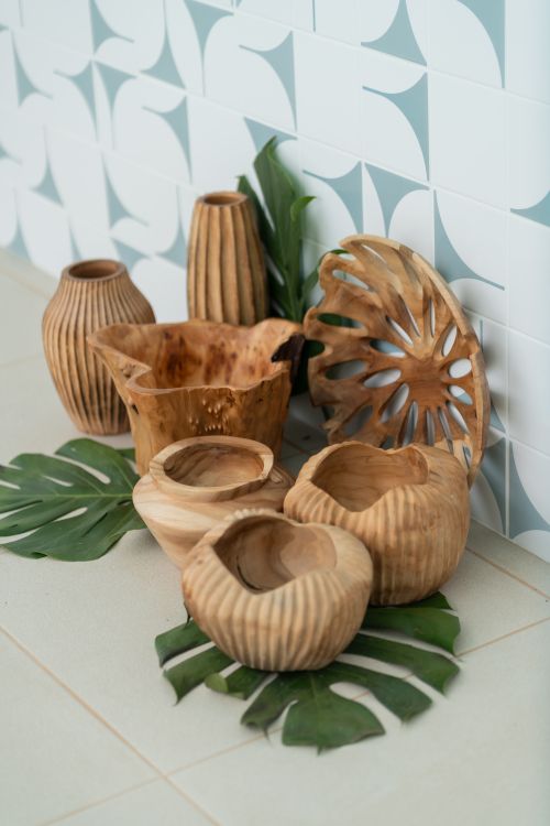 Free A collection of rustic wooden decor items against a patterned tiled wall, evoking natural elegance. Stock Photo