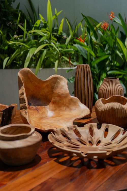 Free Beautiful rustic wooden decor displayed on a wooden table surrounded by greenery, perfect for natural home styling. Stock Photo