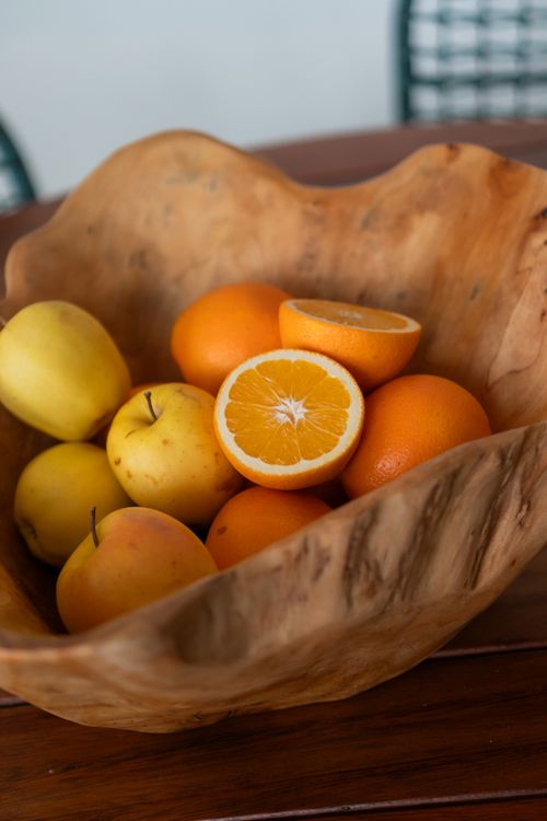 Free A wooden bowl filled with fresh oranges and apples, perfect for rustic kitchen decor. Stock Photo