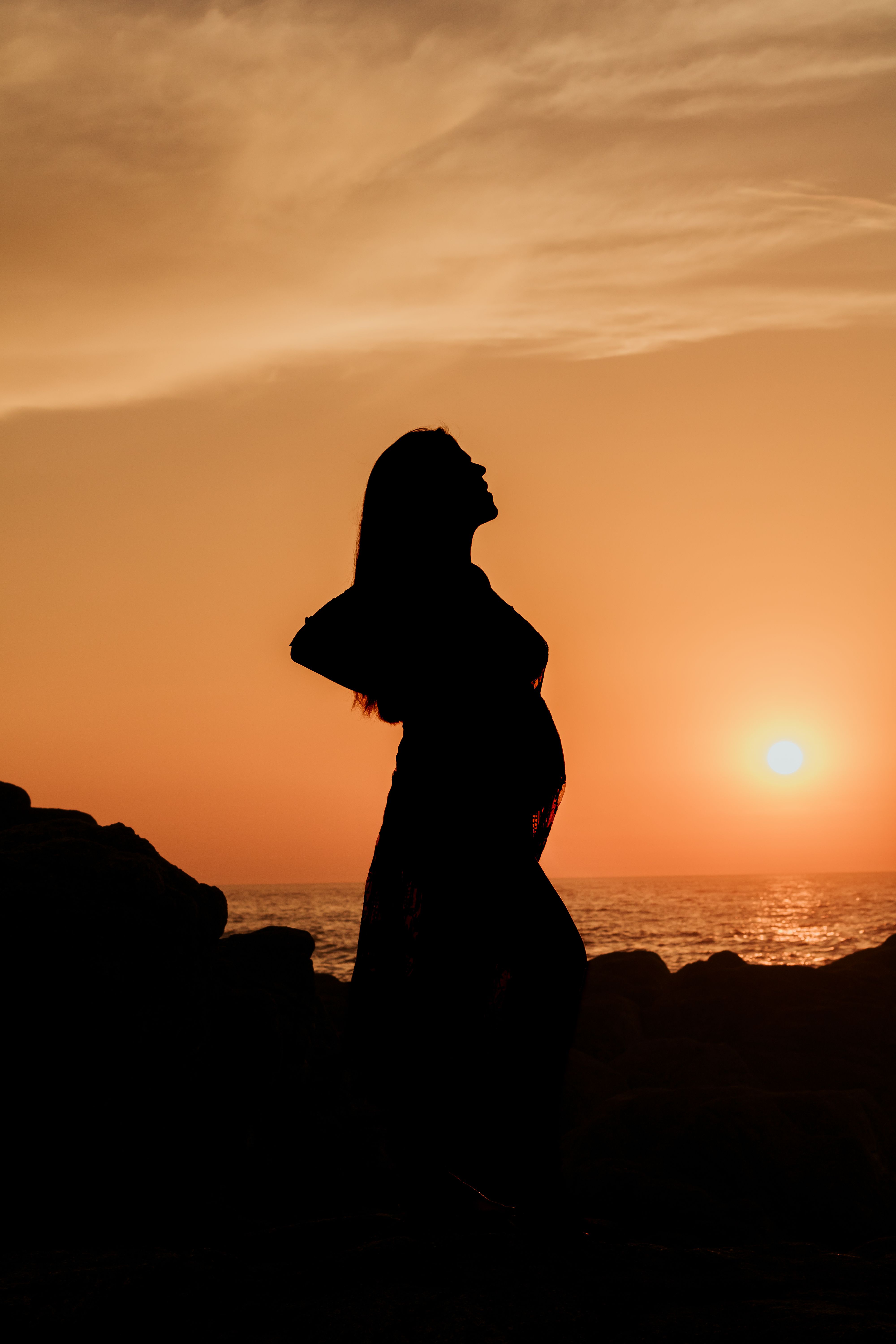 Silhouette of Woman on Beach at Sunset · Free Stock Photo