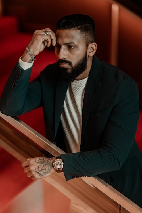A man with a beard and a watch on his wrist
