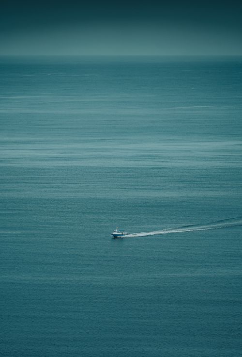 Free A tranquil aerial view of a motorboat sailing on the vast ocean near Badjo, Indonesia. Stock Photo