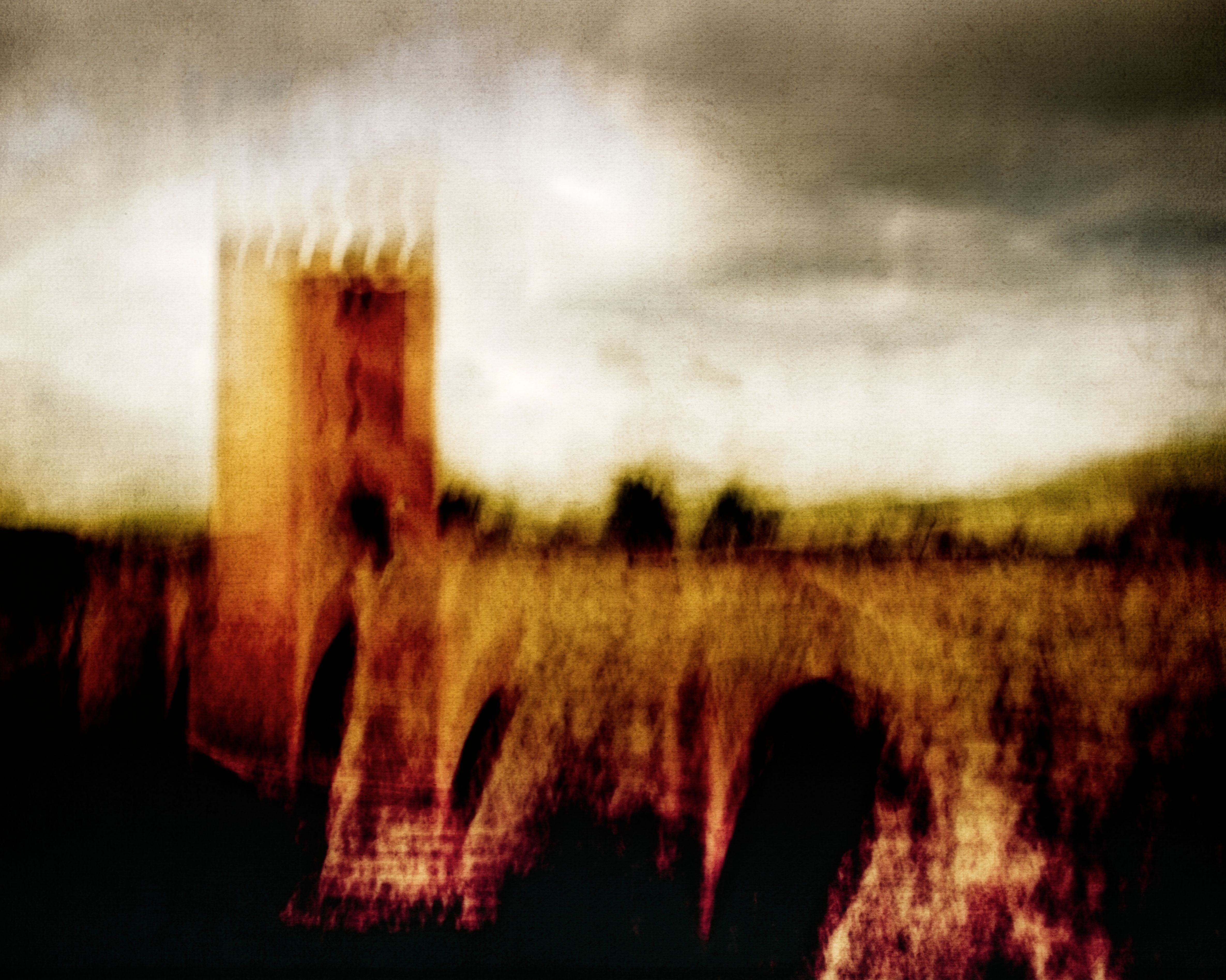Artistic blurred image of a historical tower with arches, creating an abstract and moody atmosphere.