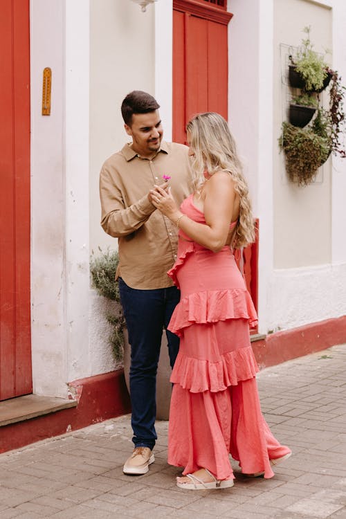 A couple standing in front of a red door