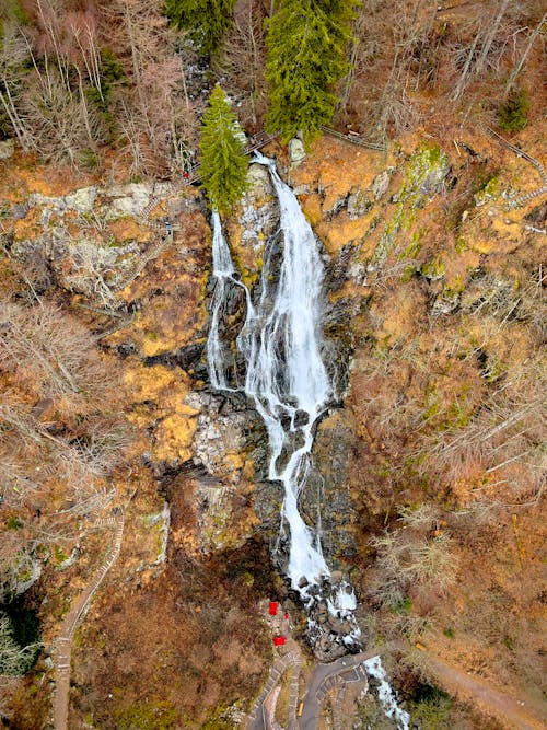 An aerial view of a waterfall in the woods