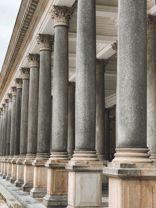 Free A classic grey stone colonnade in Karlovy Vary, showcasing detailed architectural design. Stock Photo