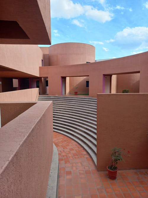 The courtyard of a building with stairs and a circular walkway