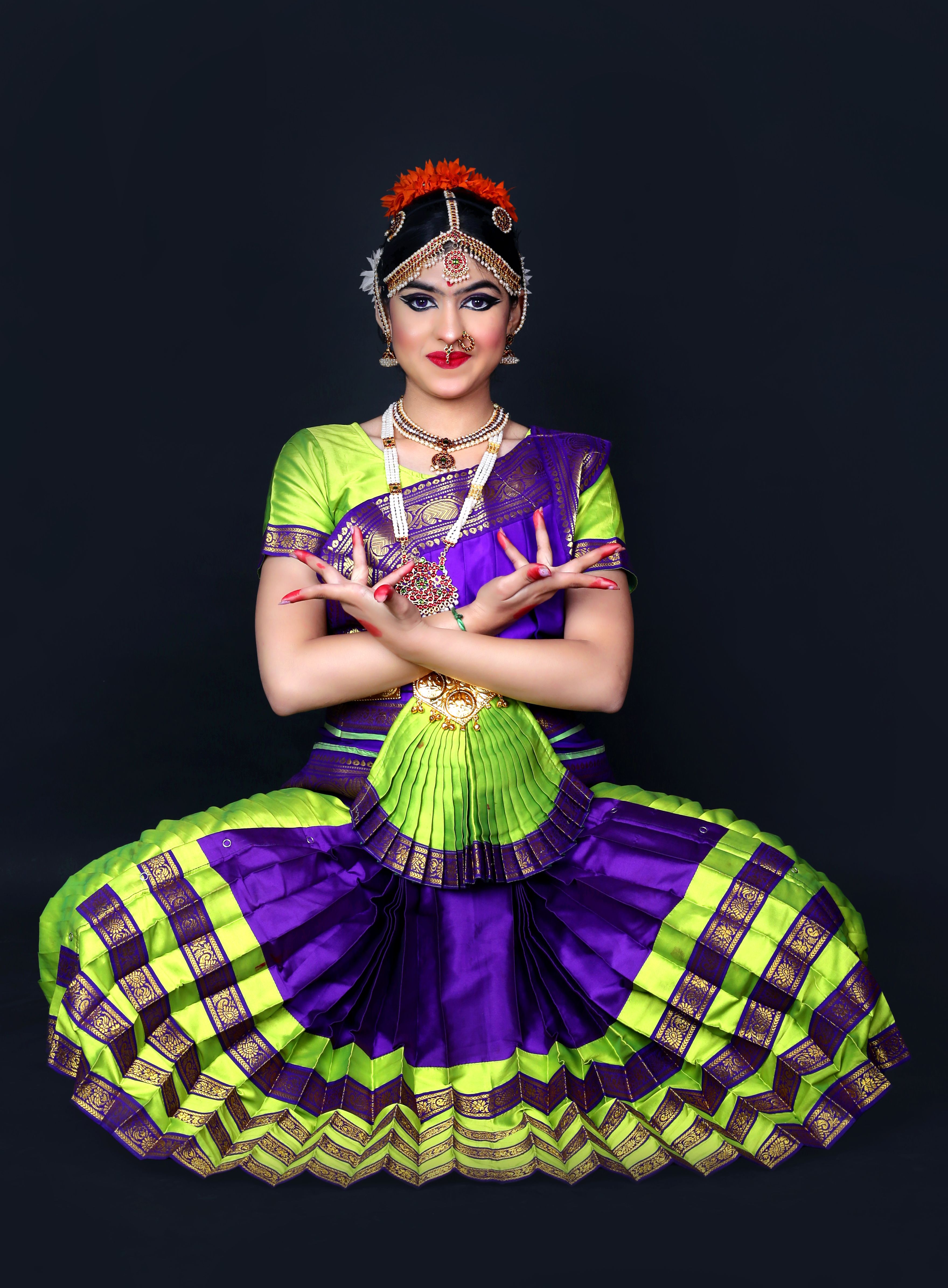 A Woman in Traditional Dress and Jewelry Posing against Black ...