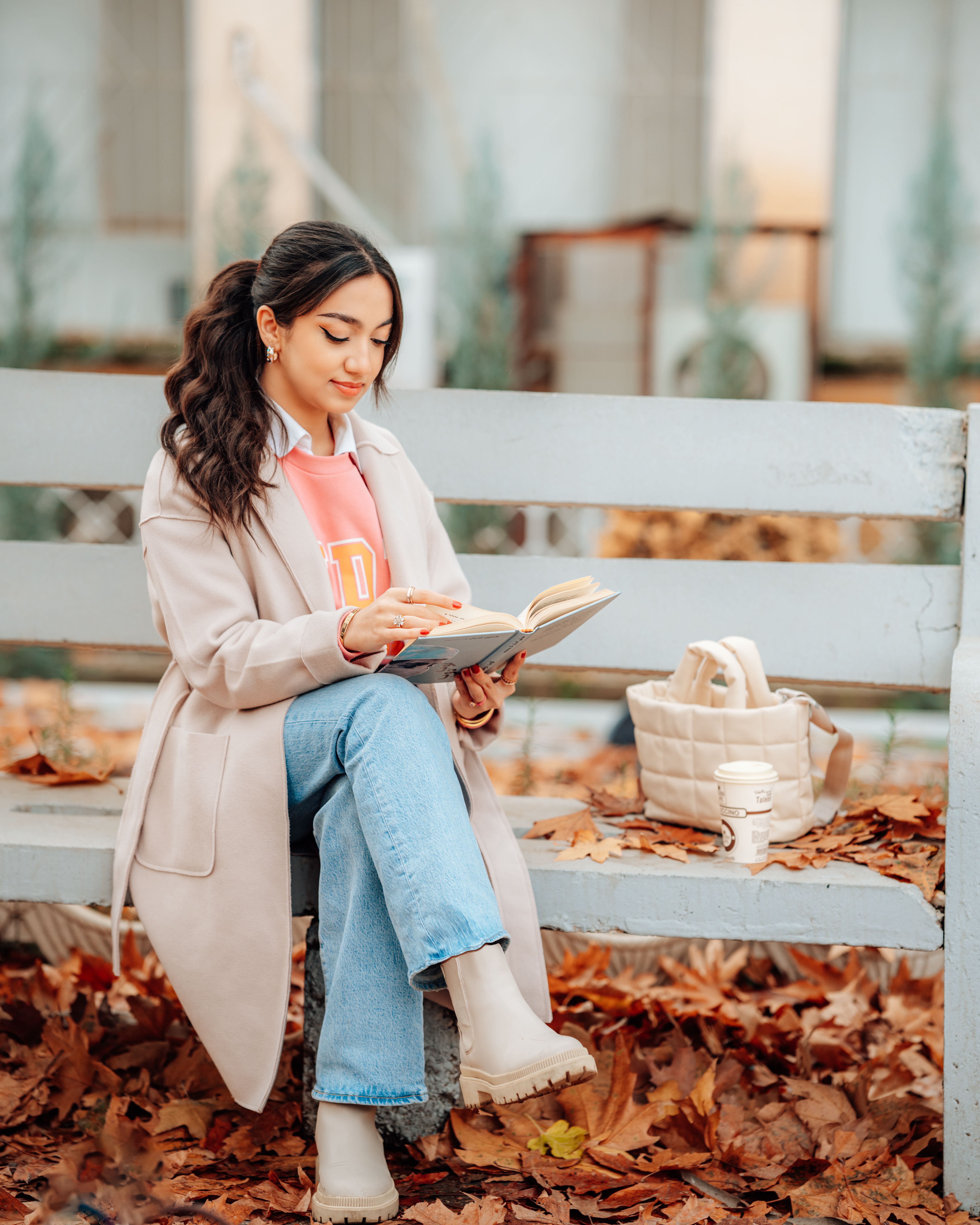 Young Woman Sitting on a Bench with a Book and Coffee · Free Stock Photo