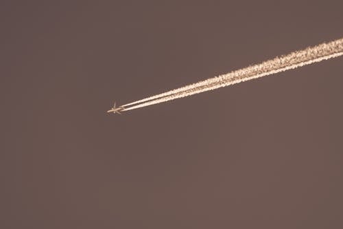 Contrail behind Flying Airplane