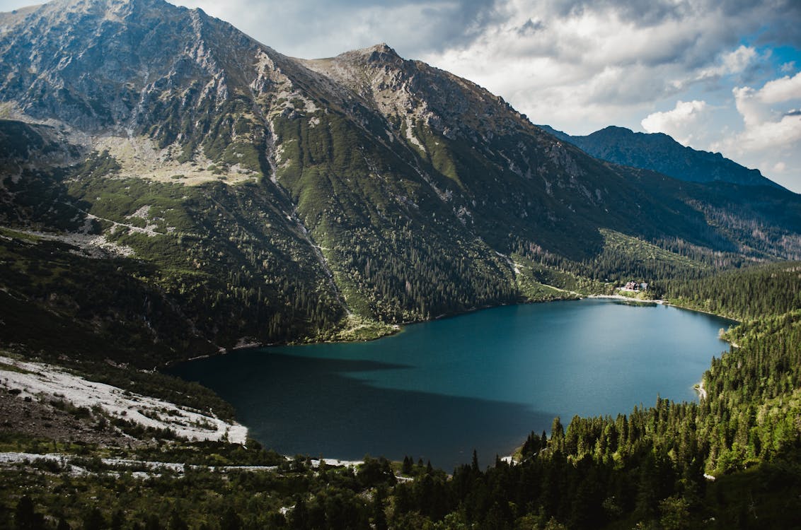 Scenic View Of Mountains Under Cloudy Sky