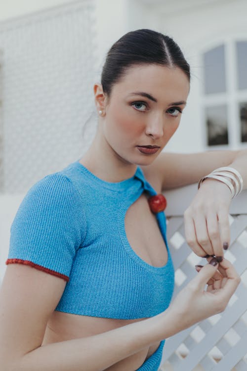 A woman in a blue top and red ring
