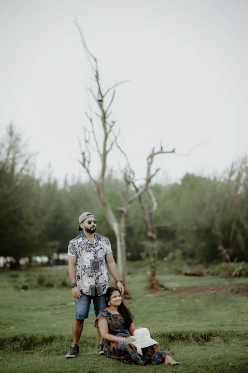 Free Man Standing over Woman in Dress Stock Photo