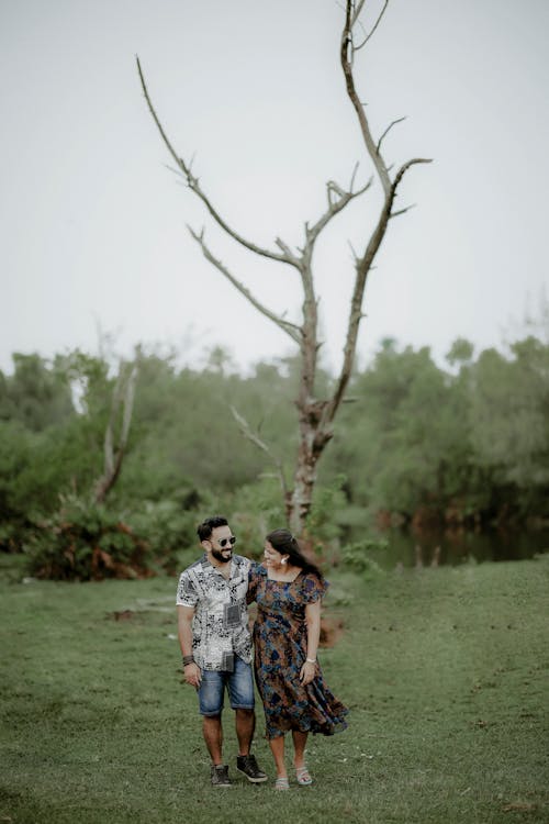 Couple Walking with Withered Tree behind