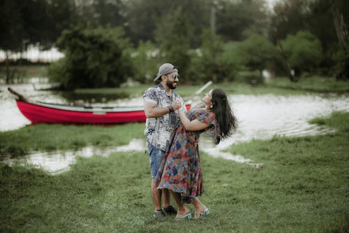 Free Couple Holding Hands and Standing Together near Pond Stock Photo