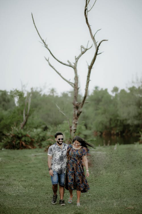 Smiling Couple Walking in Dress and Shirt