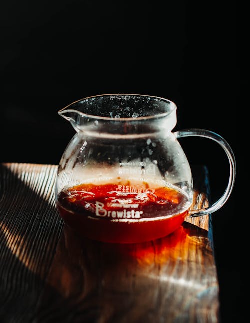 Clear Glass Pitcher On Brown Wooden Surface