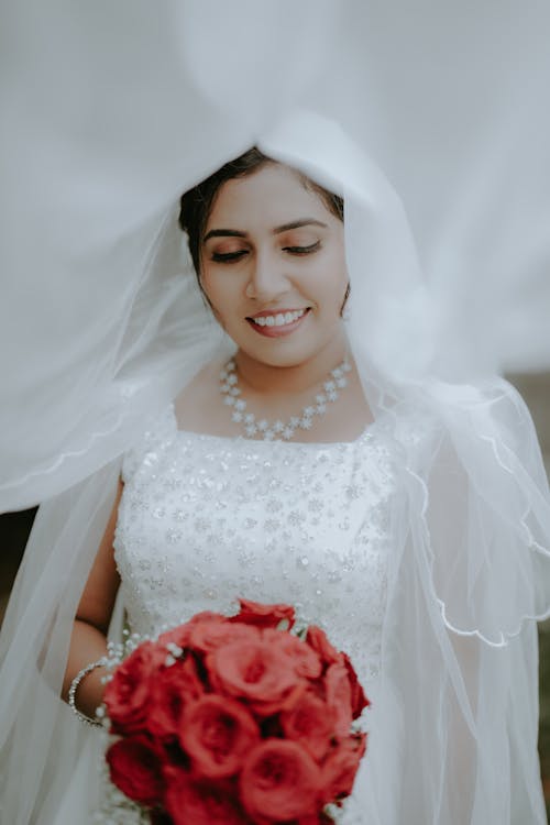 Portrait of Smiling Bride with Flowers Bouquet