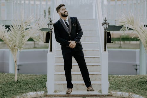 A man in a suit standing on some stairs