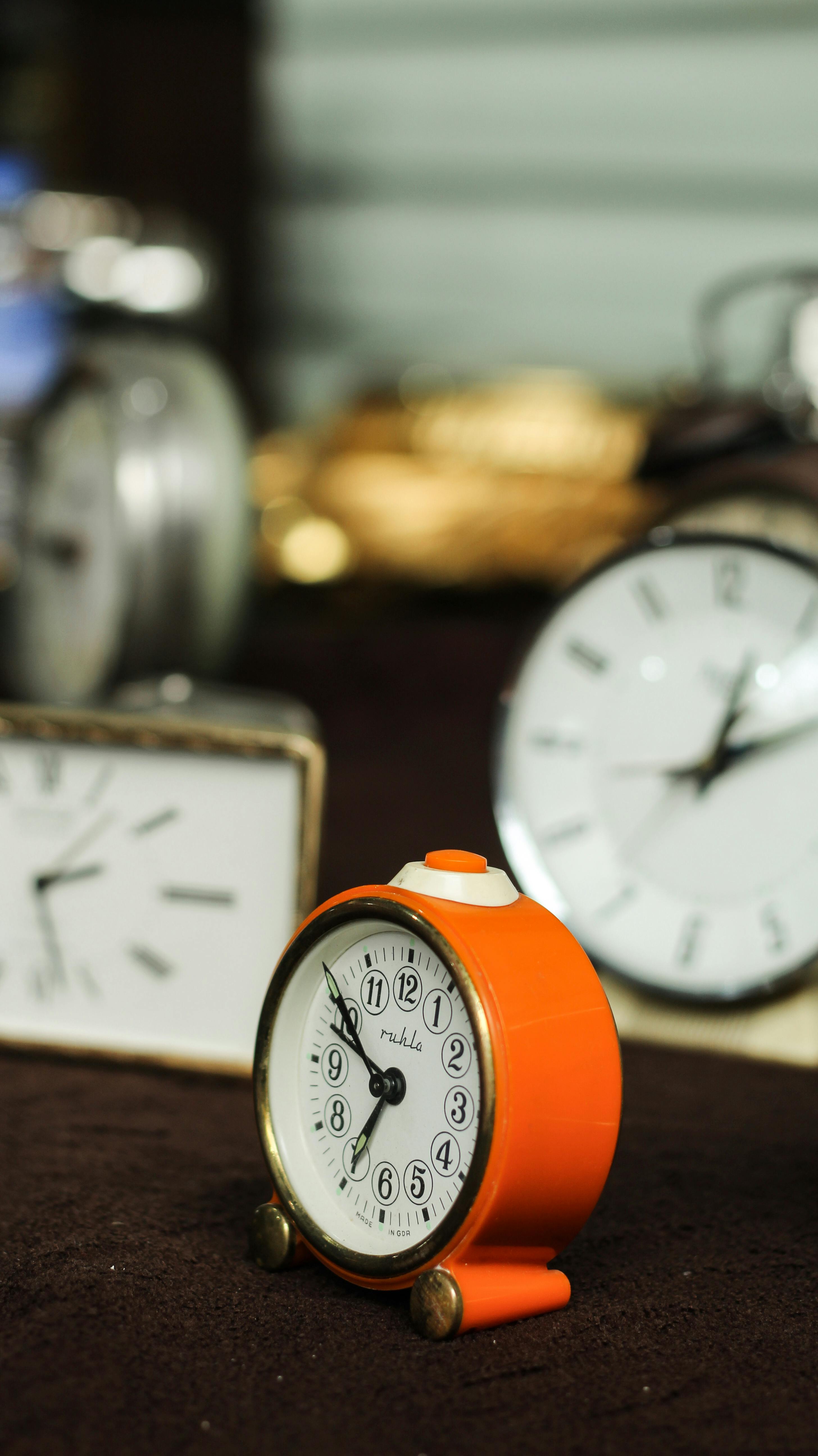 Vintage alarm clocks in various styles and colors displayed together.