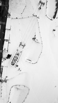 Aerial black and white view of El Pas de la Casa ski resort in winter snow.