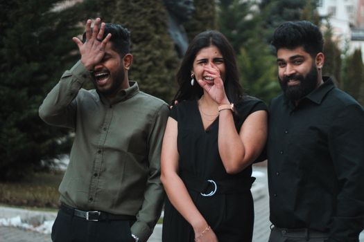 Group of friends enjoying a laugh outdoors on a winter day, showcasing friendship and happiness.