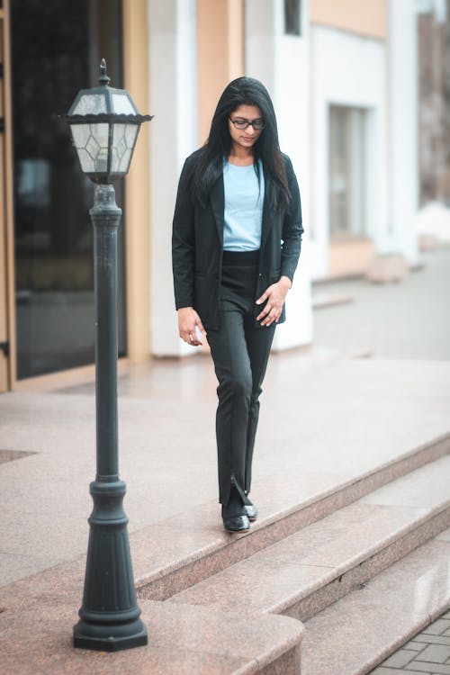 A woman in a business suit walking down the steps