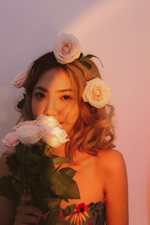 Portrait of a Pretty Brunette Holding a Bunch of Pink Roses