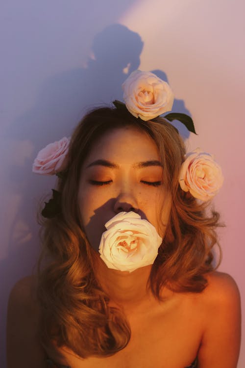 Woman with Roses in Hair and Mouth