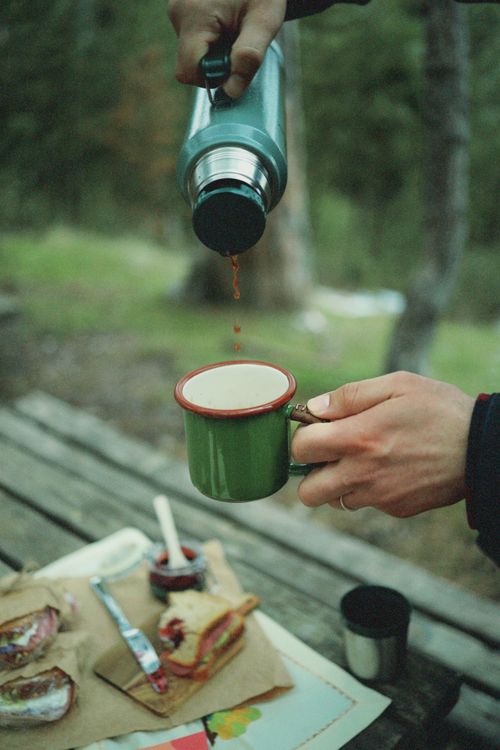 Free Enjoy a warm drink poured from a thermos during a serene outdoor picnic. Stock Photo