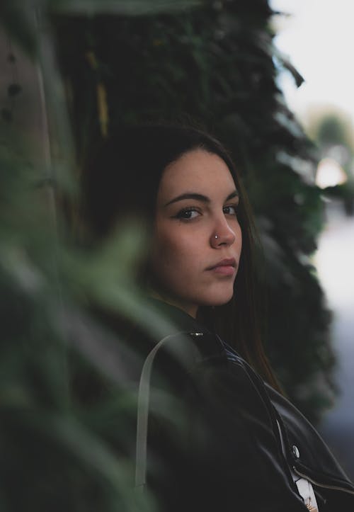 Portrait of Brunette Woman in Front of an Ivy 