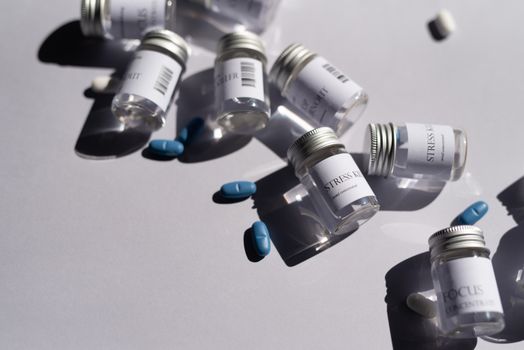 Close-up of medicine bottles and blue pills on a white background, emphasizing healthcare.