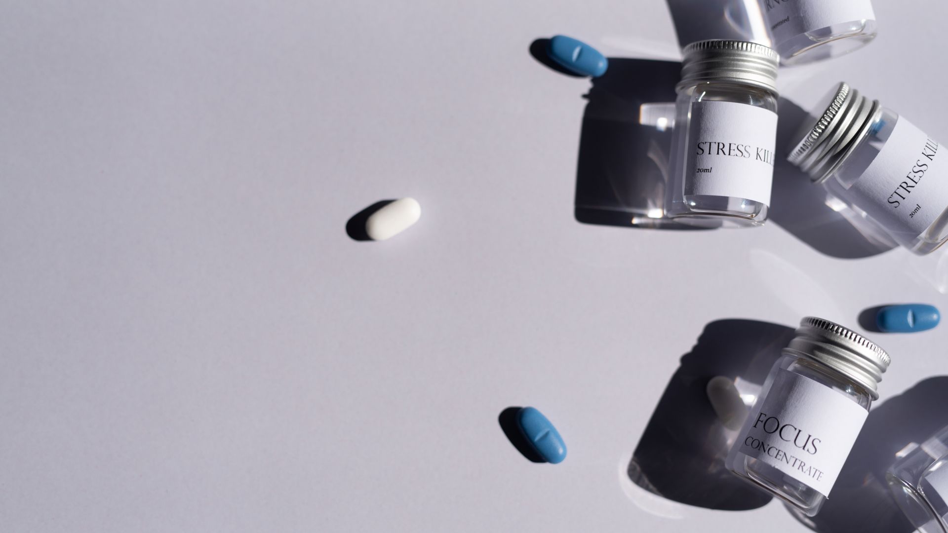 Modafinil Neurotransmitters: Unlocking the Brain's Chemistry Flat lay of medicine bottles and pills on a white background, perfect for healthcare themes.