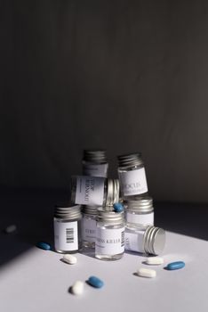 Various medicine bottles and pills arranged artfully on a white background.