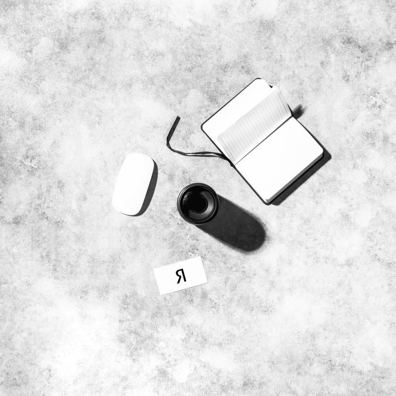 Notepad and small objects on a pale desk — photo by Adrian Regeci on Pexels
