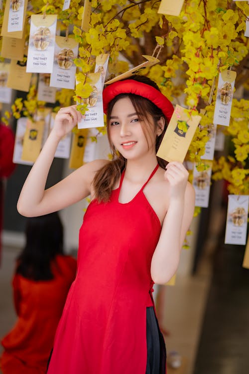 A woman in red holding up yellow cards