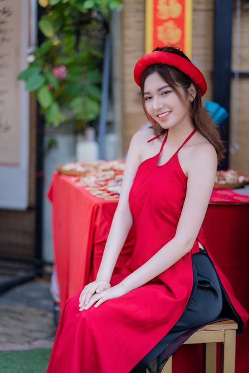 Young Woman Posing in a Traditional Red Ao Dai Dress